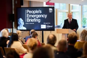 First Minister, John Swinney, presenting at the NEB event at Scottish Parliament.